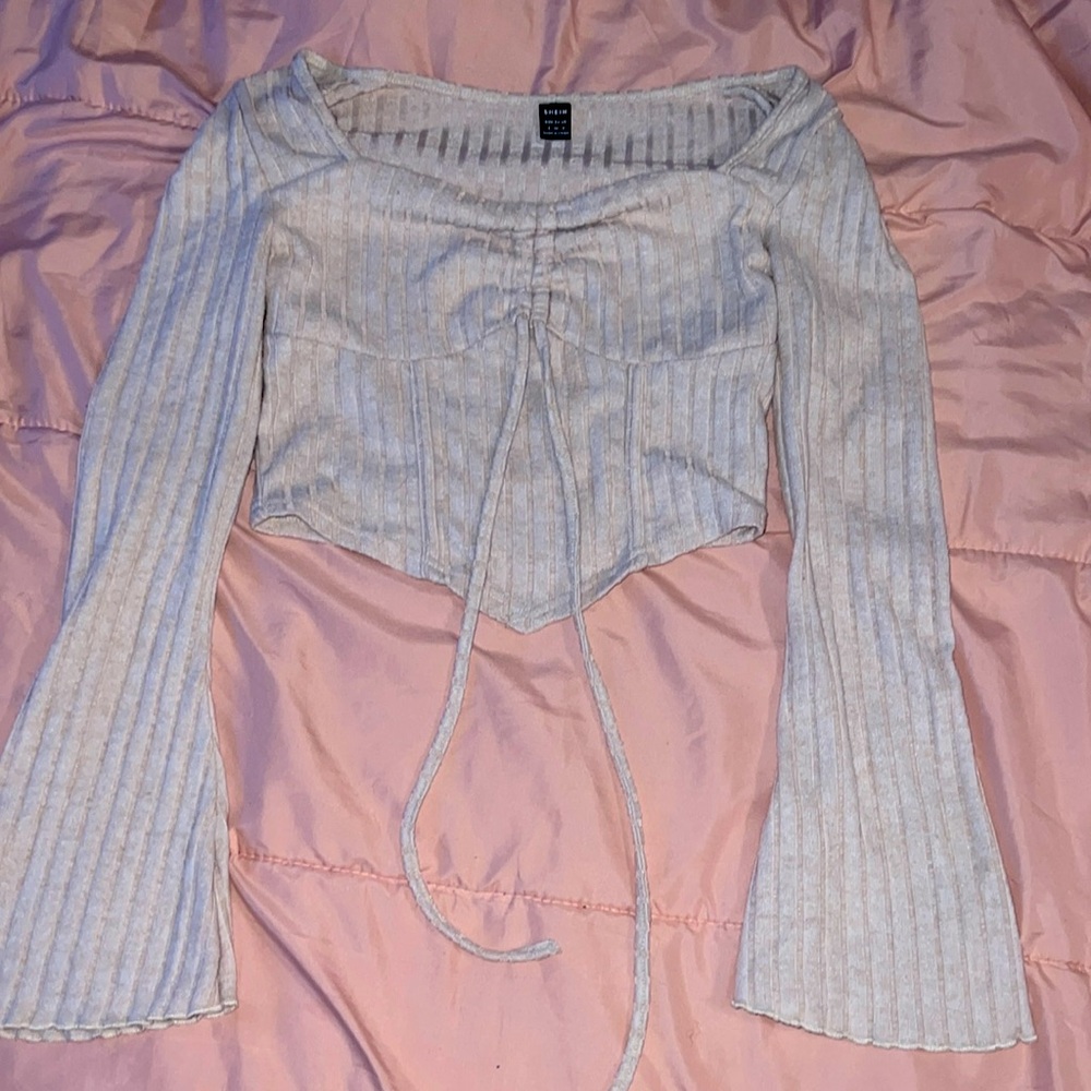 beige top with flare sleeves is a little cropped on me,doesn’t show belly button